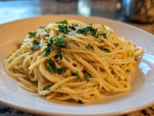 A close-up of a plate of Creamy Lemon Pasta, garnished with fresh parsley and grated Parmesan cheese.