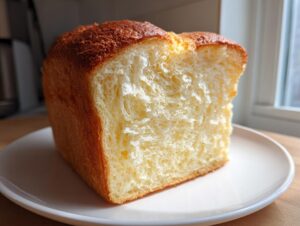 A close-up cross-section showing the incredibly soft, white, and fluffy crumb of homemade japanese milk bread.