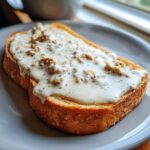 A close-up of one slice of golden toast generously covered with creamy chipped beef on toast sauce.