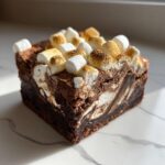 A rich, fudgy square of hot chocolate brownies topped with toasted and untoasted marshmallows.
