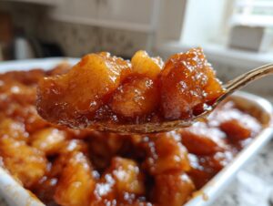 A spoonful of glistening, caramelized apple pie filling recipe, rich with cinnamon and spices.