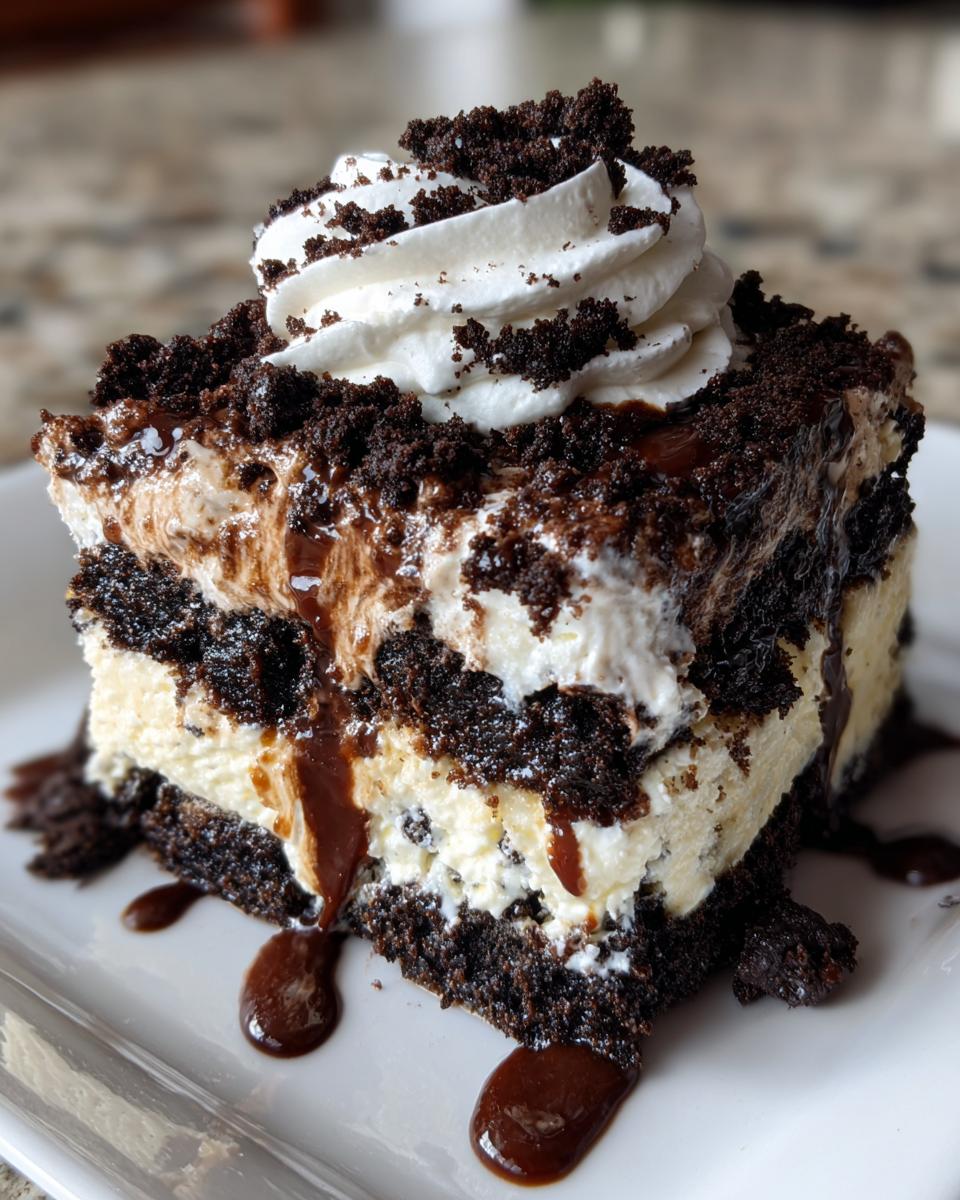 A rich slice of Baileys Chocolate Cheesecake Trifle featuring layers of dark chocolate cake, creamy filling, topped with whipped cream and chocolate drizzle.